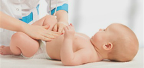 a baby being examined by a doctor